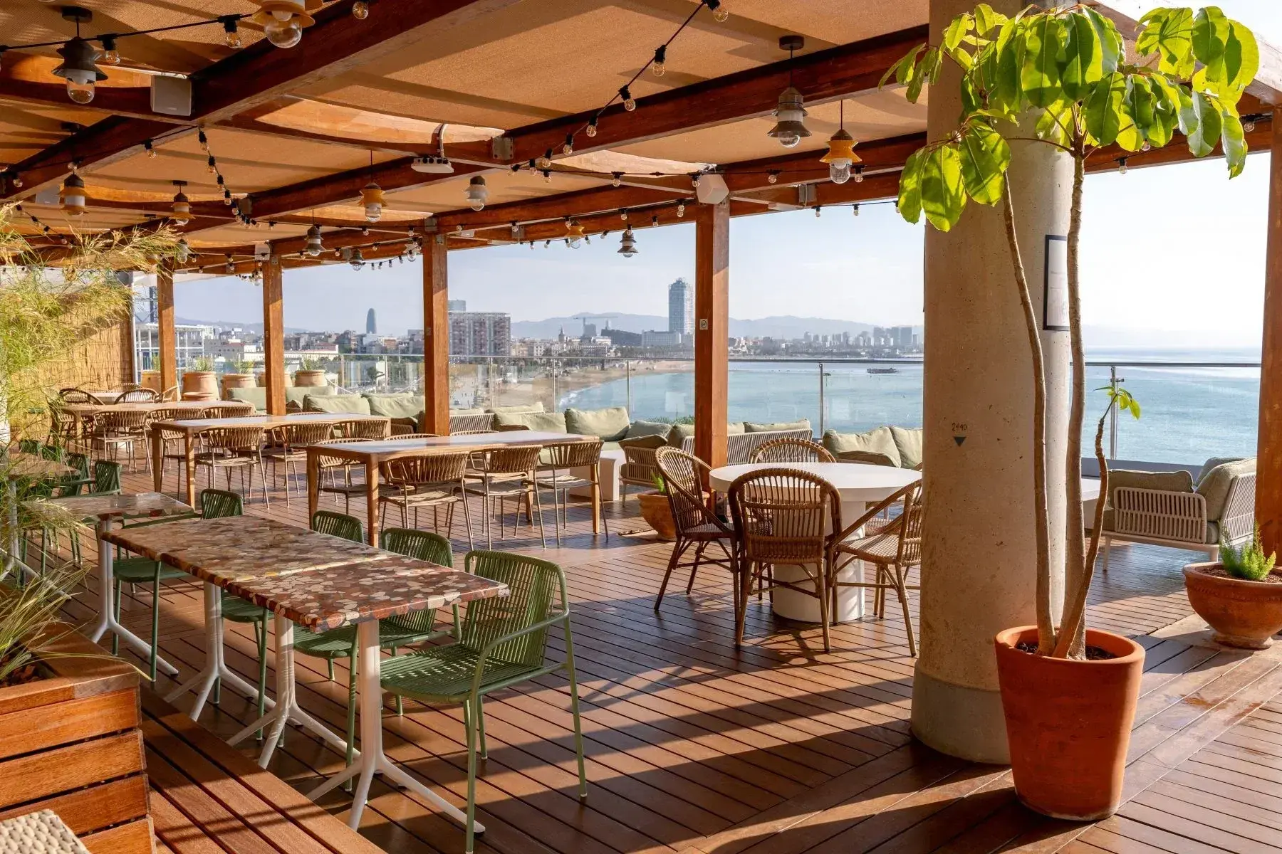 Rooftop terrace with wooden pergola overlooking the city and sea